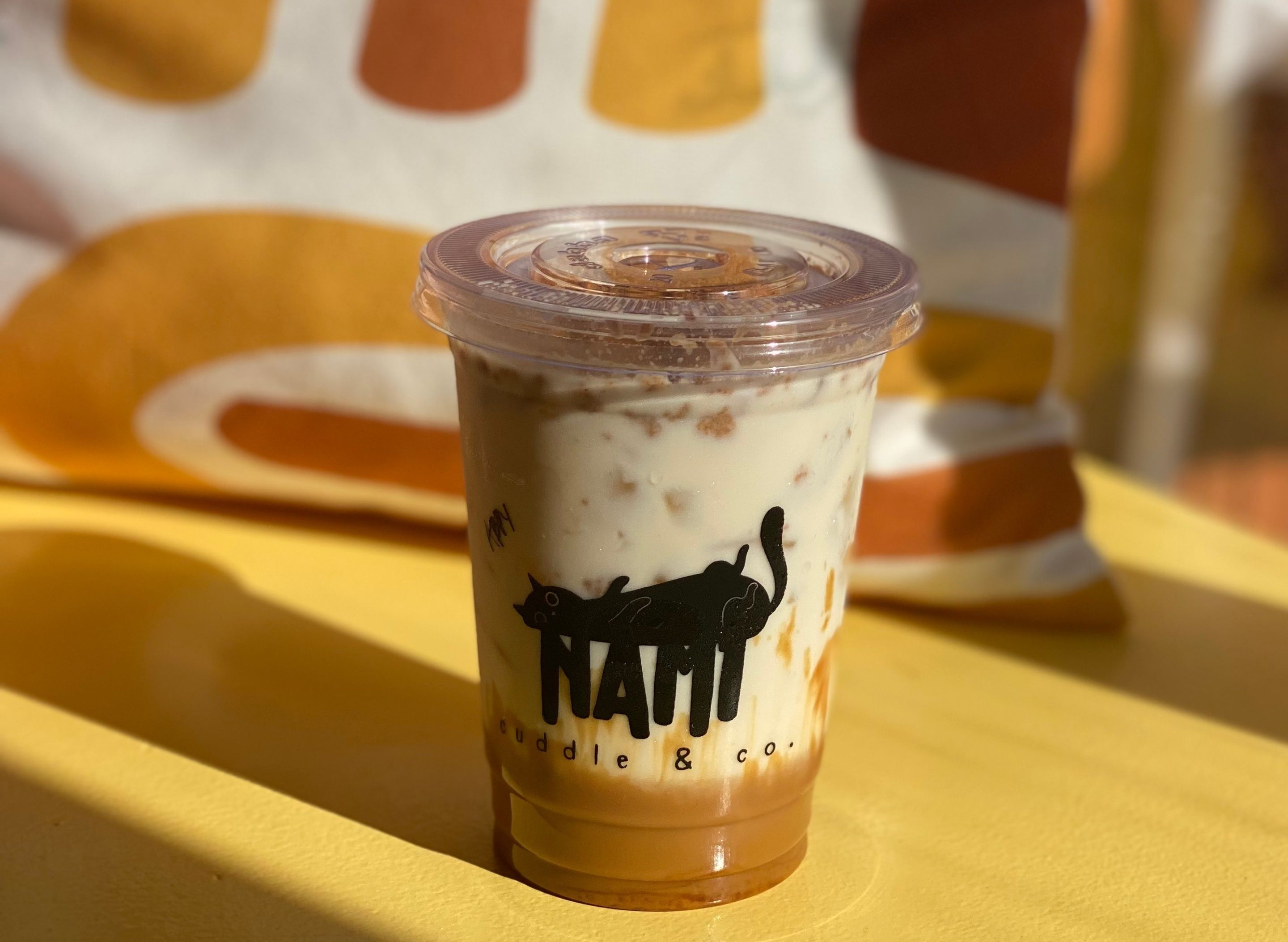 Nami's Cuddle Cafe - Adelfa Street vendor logo