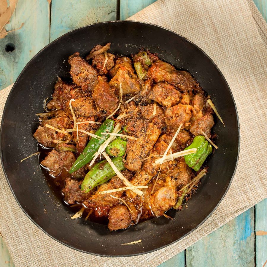 Mutton Sulemani style karahi in a traditional black wok