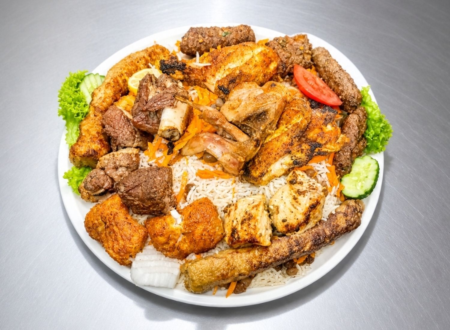 Mixed Pakistani grill platter with rice, chicken, beef, seekh kebab and fish