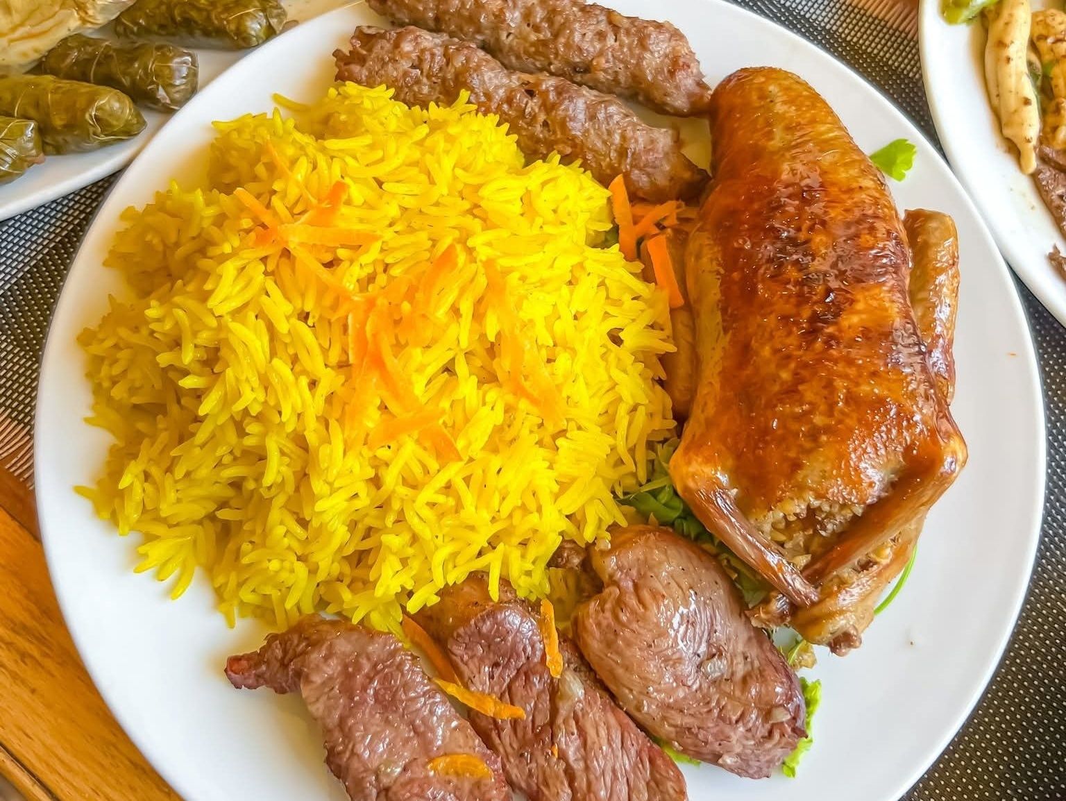 Stuffed pigeon with rice, kofta, and kebab