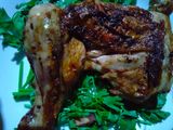 2 pieces grilled chicken thighs on charcoal