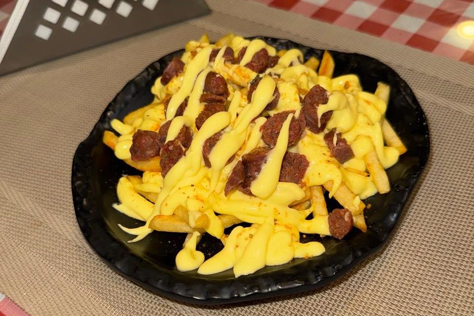 French fries with sausage in cheese sauce