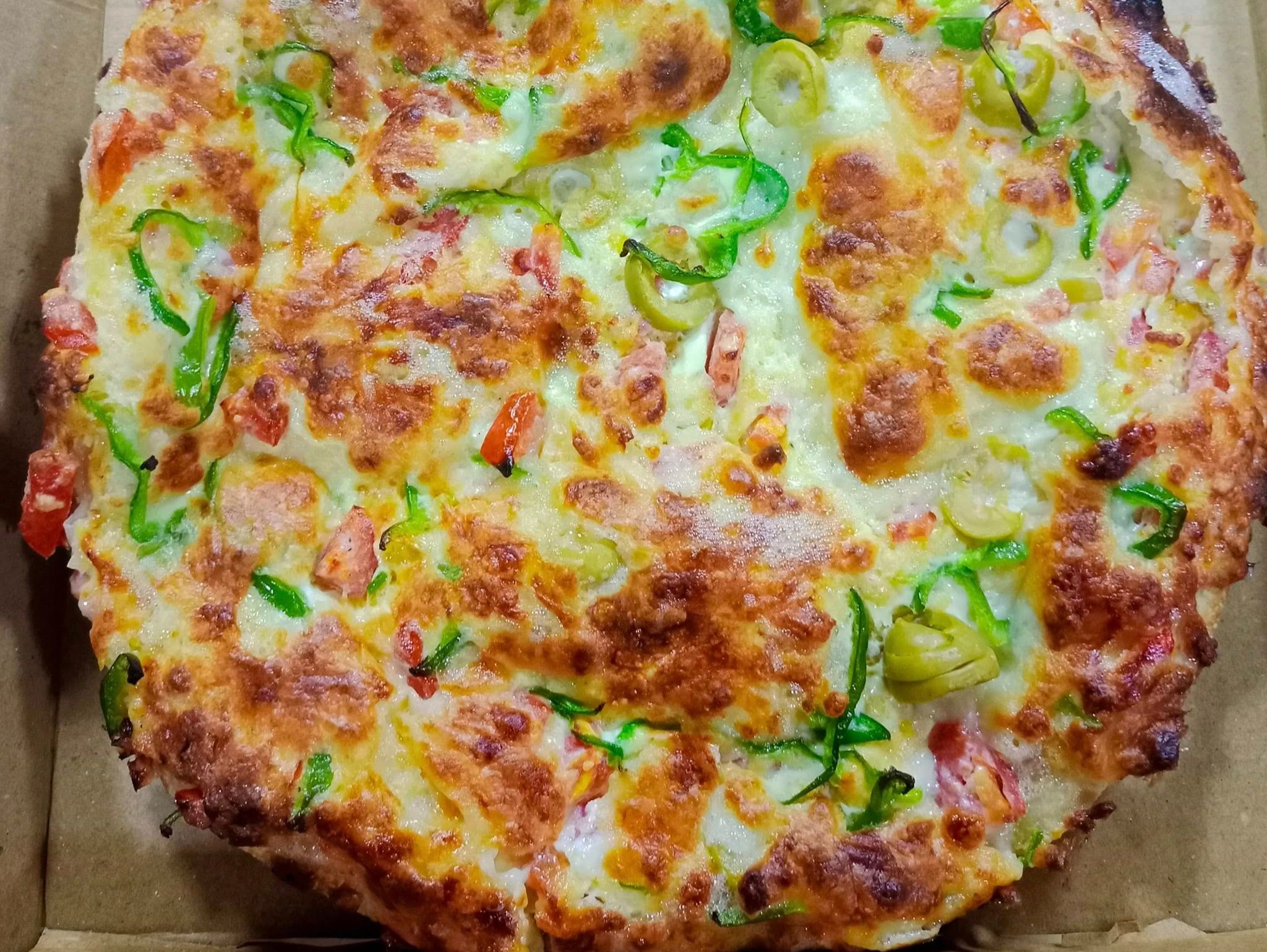 Oriental pizza with sujuk, basturma, and Kiri cheese