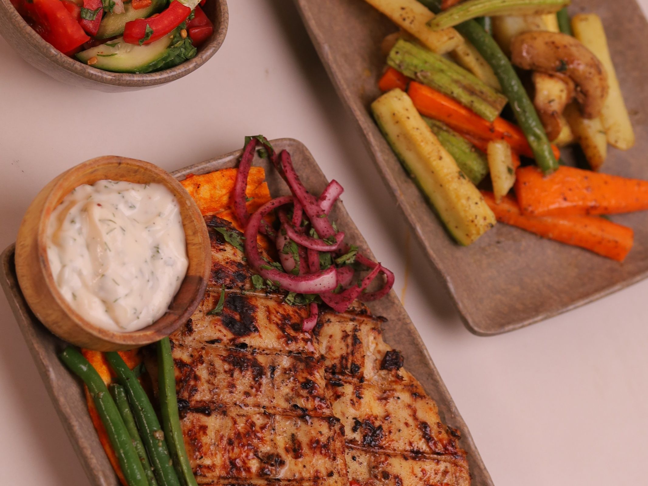 Grilled chicken breasts with sautéed vegetables and green salad