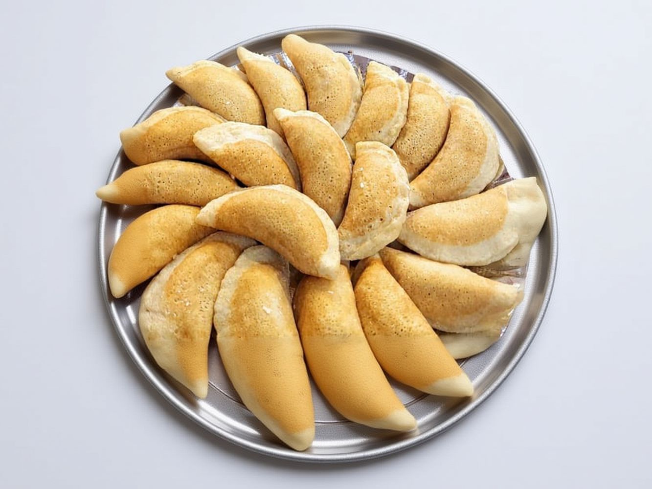 Qatayef Stuffed With Peanut, Raisins And Coconut