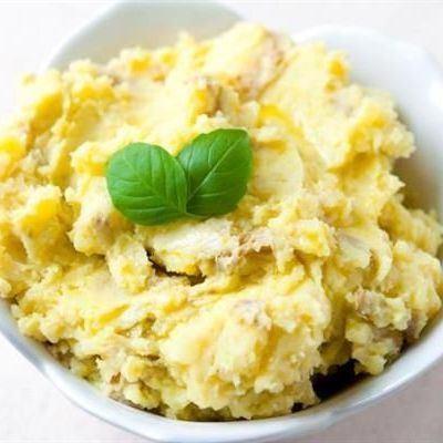 Box of mashed potatoes with boiled eggs