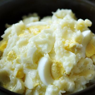 A dish of mashed potatoes with boiled eggs