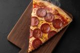 Large size pizza slice with smoked sausage