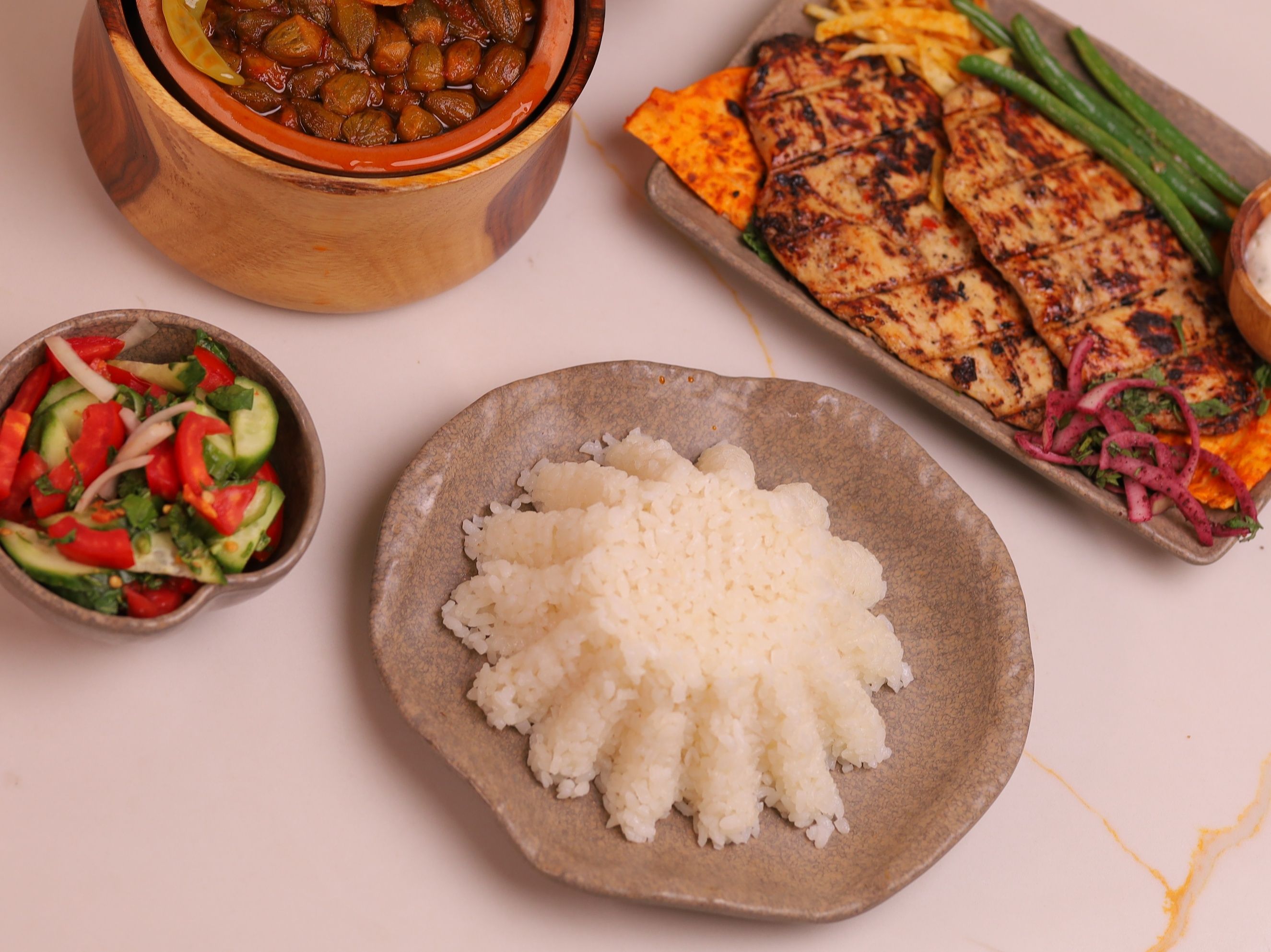 Grilled chicken breasts with white rice, mixed vegetables, and green salad