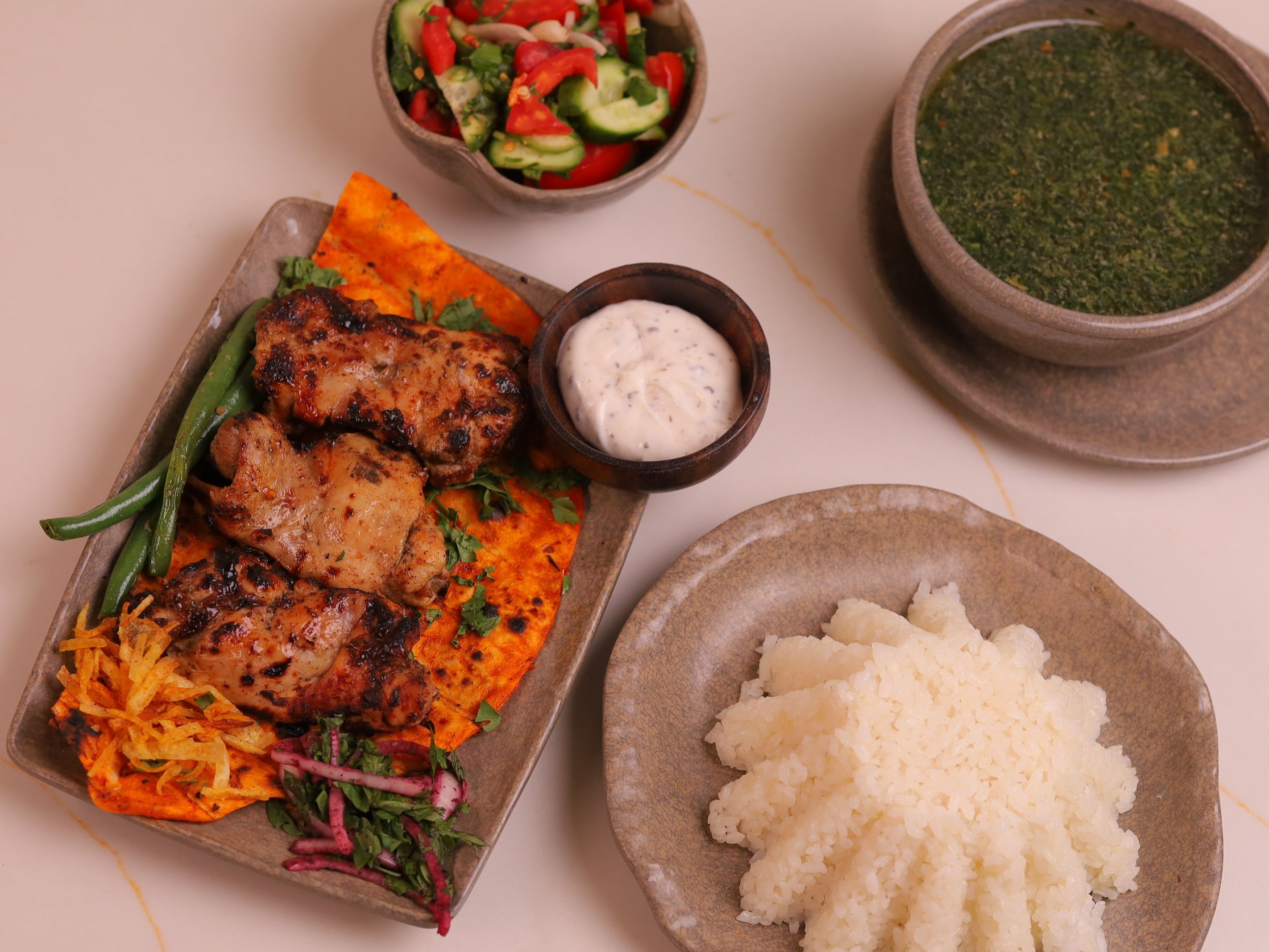 Chicken shish tawook with white rice, molokhia, and green salad