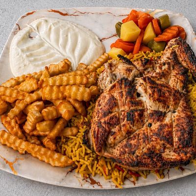 Quarter grilled chicken breast on charcoal