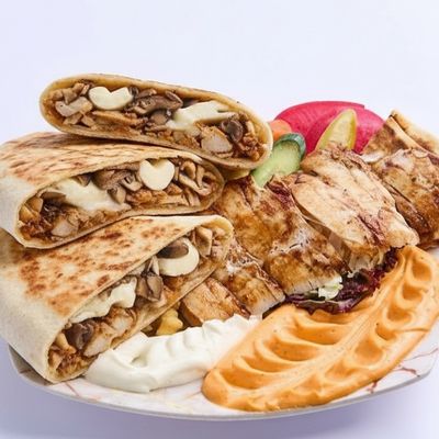 Two chicken shawarma discs in tortilla bread