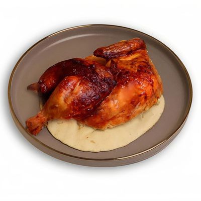 Half grilled chicken on charcoal
