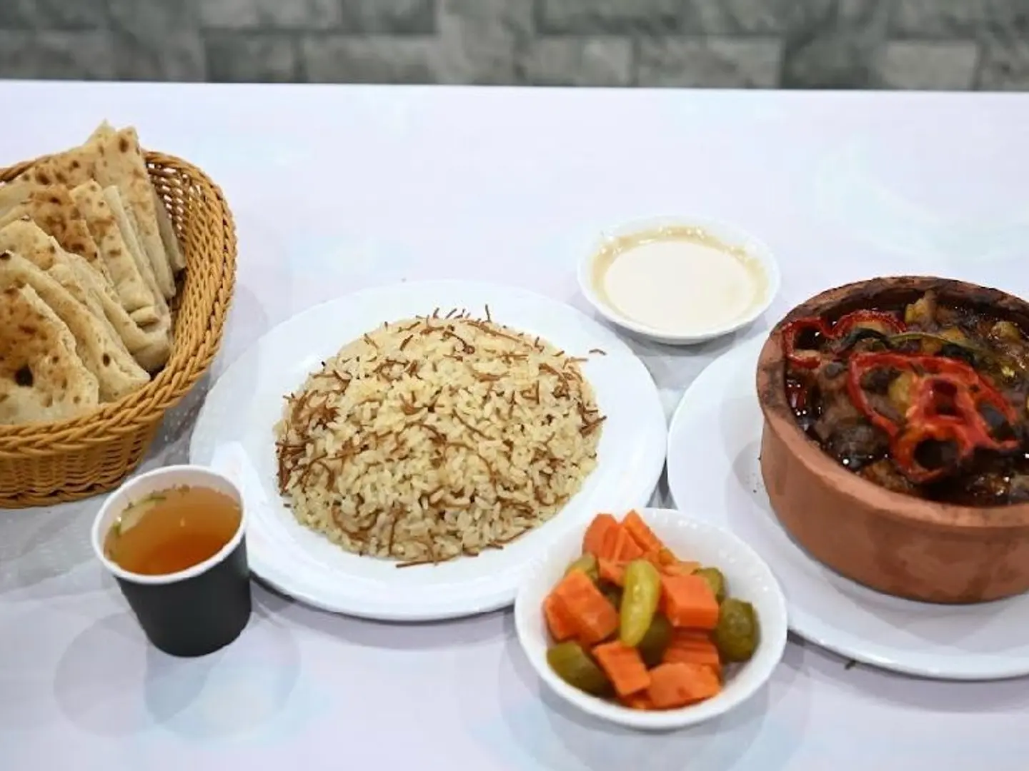 Pea And Carrot Tagine With Meat, Served With Vermicelli Rice, Orzo Soup, Bread, And Salads