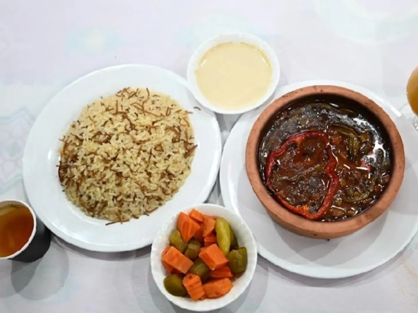 Okra Tagine With Meat Served With Vermicelli Rice, Orzo Soup, Bread, And Salads