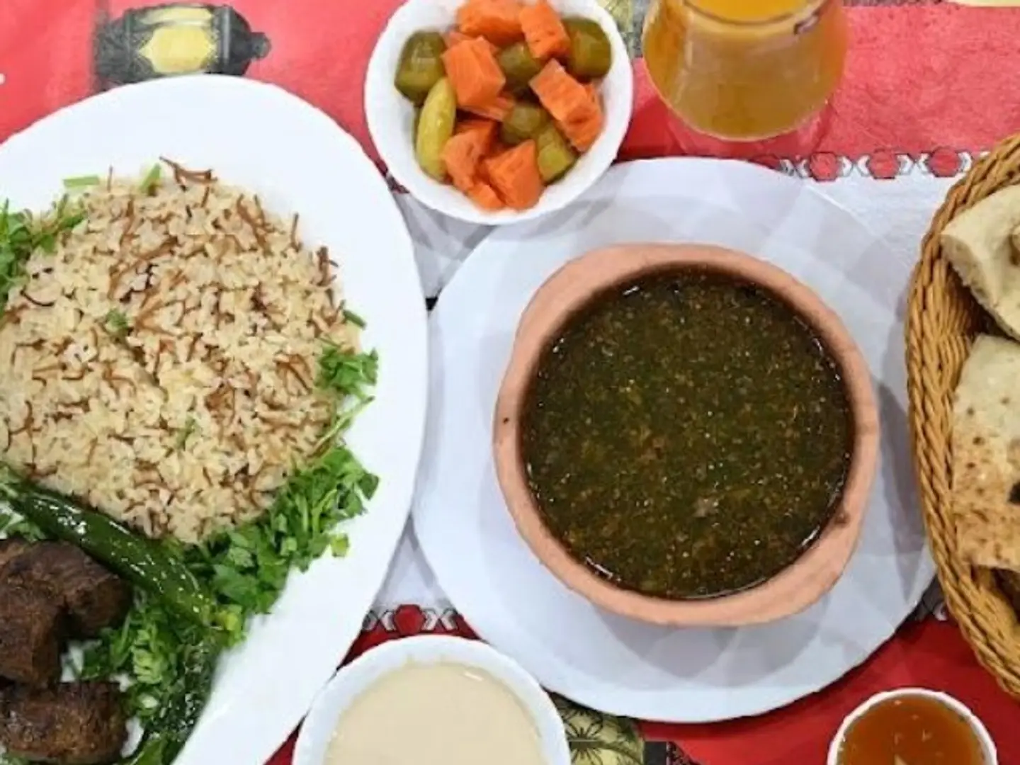 Roasted Meat Meal Served With Vermicelli Rice, Molokhia, Orzo Soup, Bread, And Salads