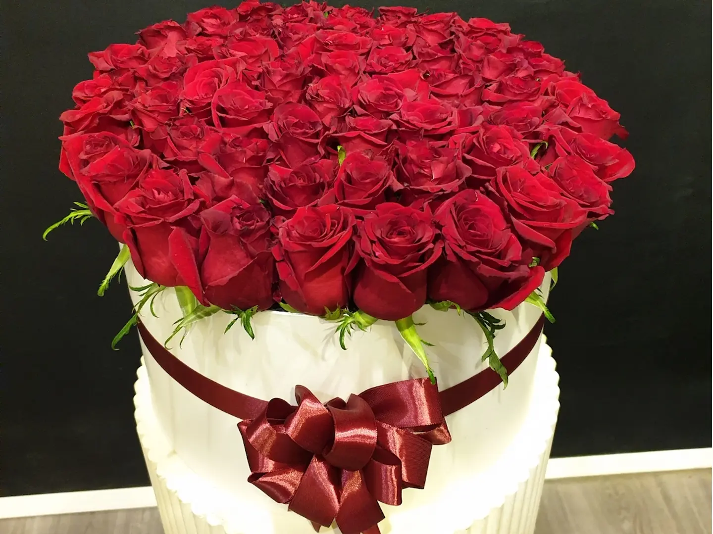 تنسيقة صندوق قبعة فاخرة بالورد الأحمر.