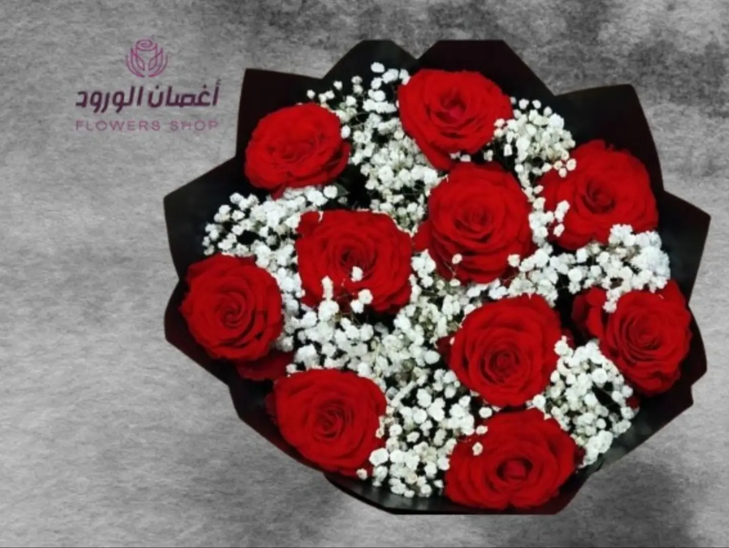 A Bouquet Of Red Roses With Black Wrapping