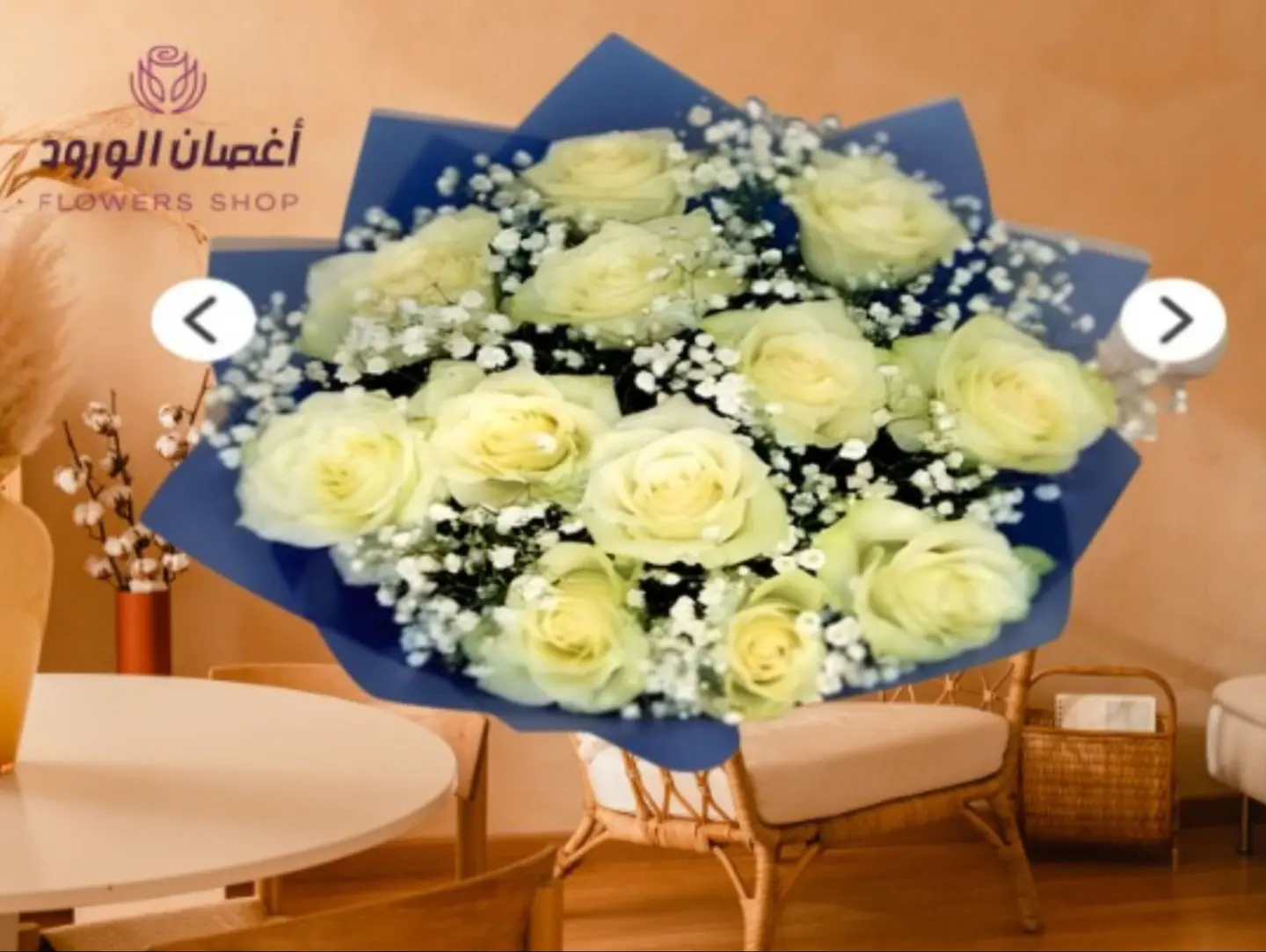 A Bouquet Of White Roses With A Blue Wrapper