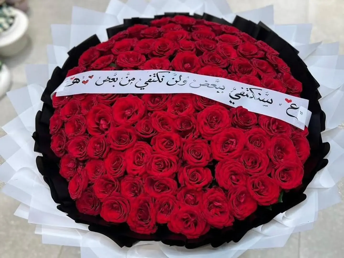 A Large Bouquet Of Red Roses And A Ribbon