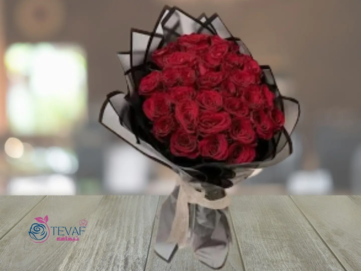 A Bouquet Of Red Roses In Black Packaging