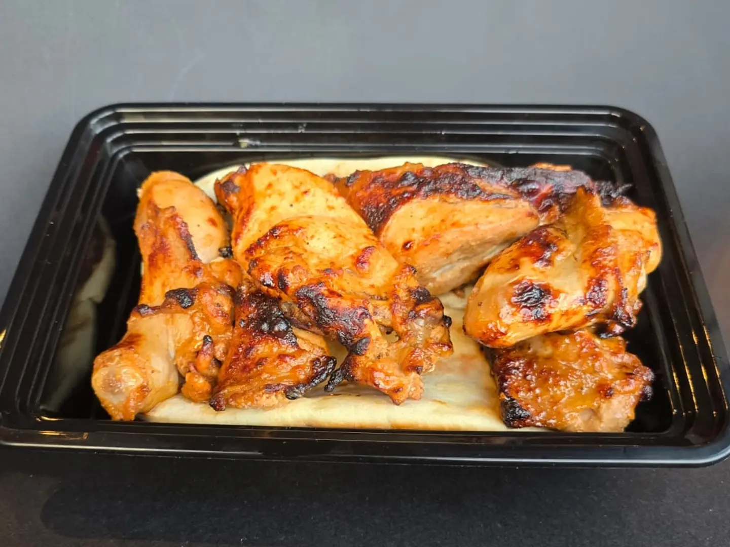 Half A Chicken Grilled On Charcoal