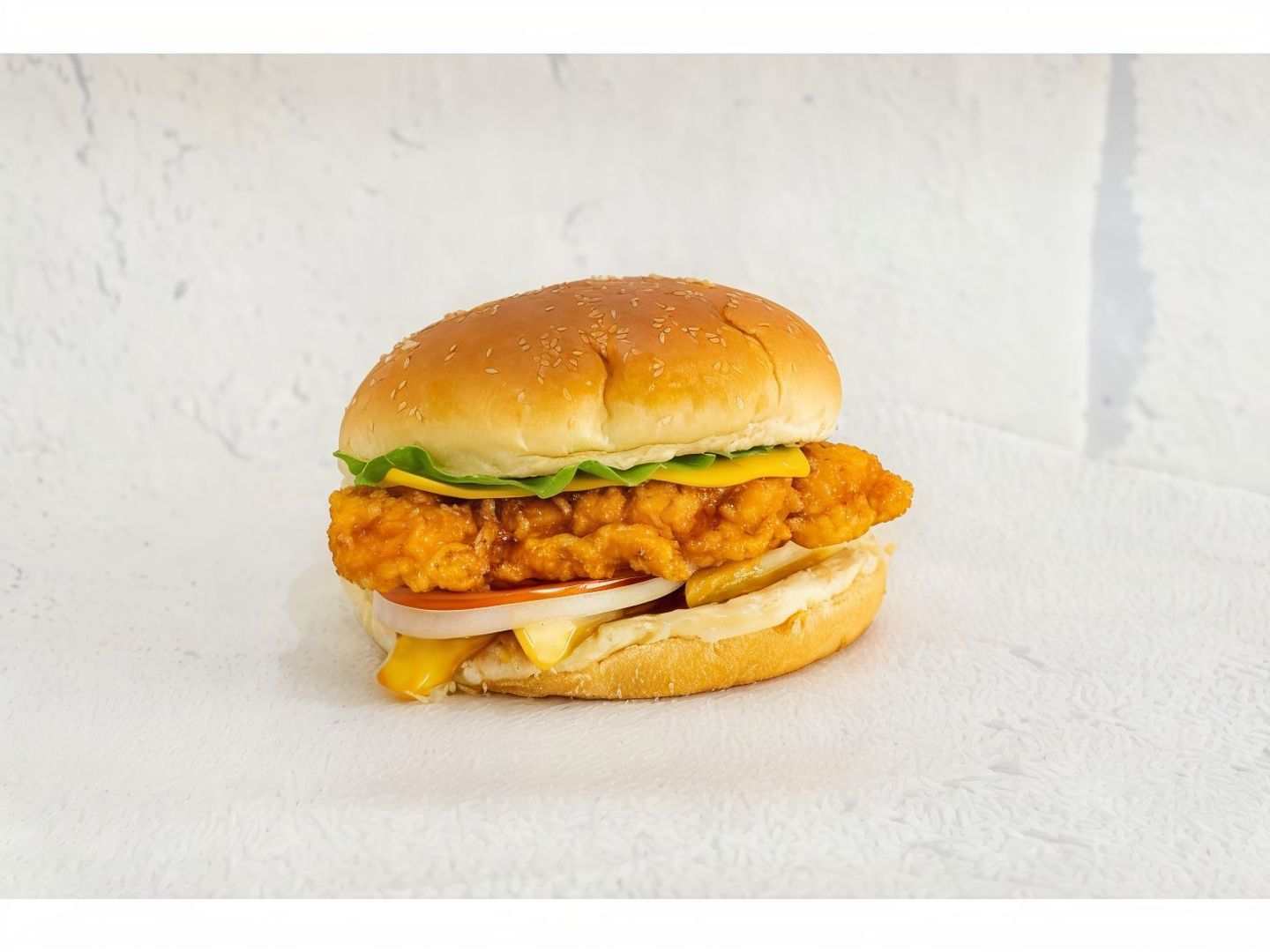 A Crispy Spicy Zinger Chicken Piece Served Inside A Burger Bun With Lettuce And Delicious Sauces