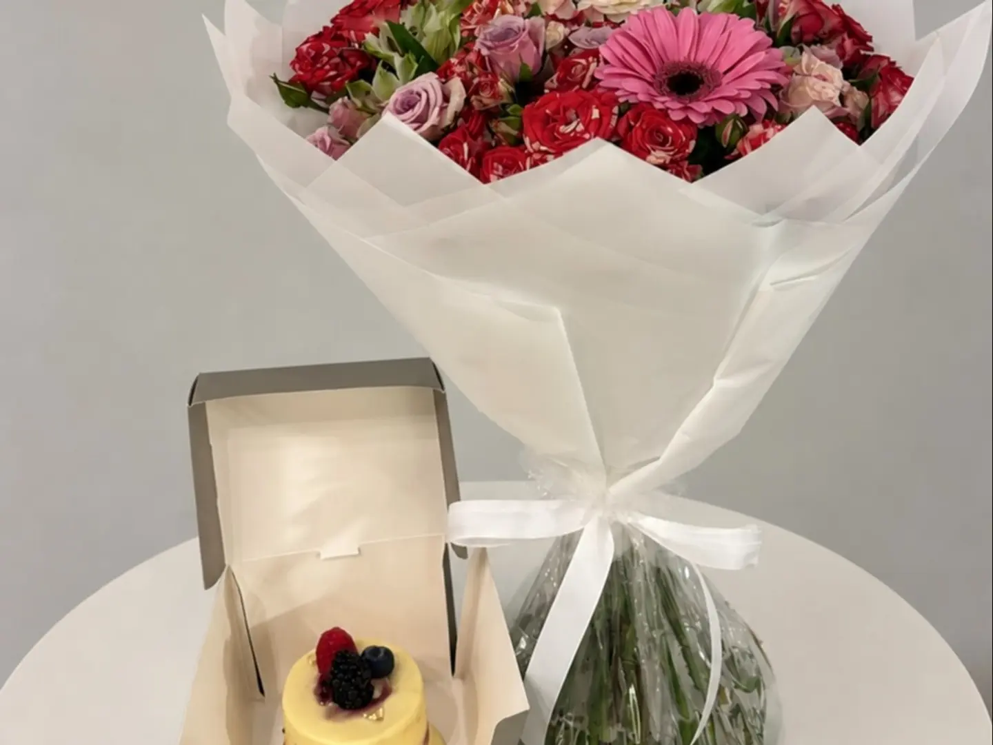 A Special Flower Bouquet Paired With A Luxurious Cake