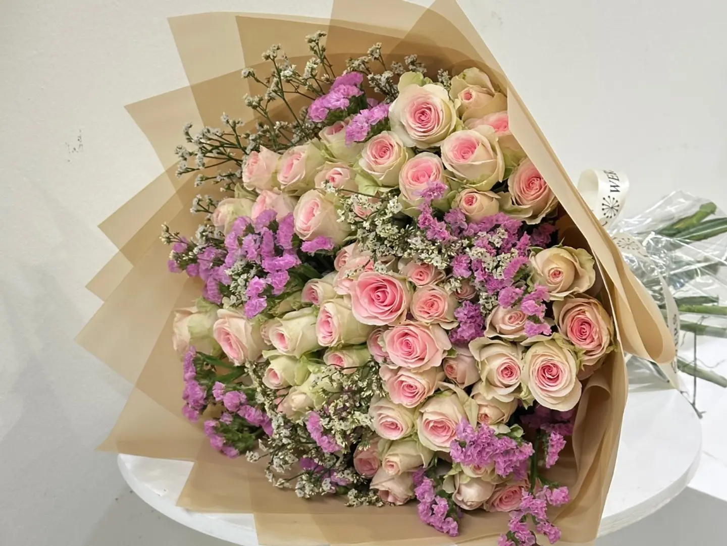 A Modern English Style Bouquet Of Spray Roes And Statice.