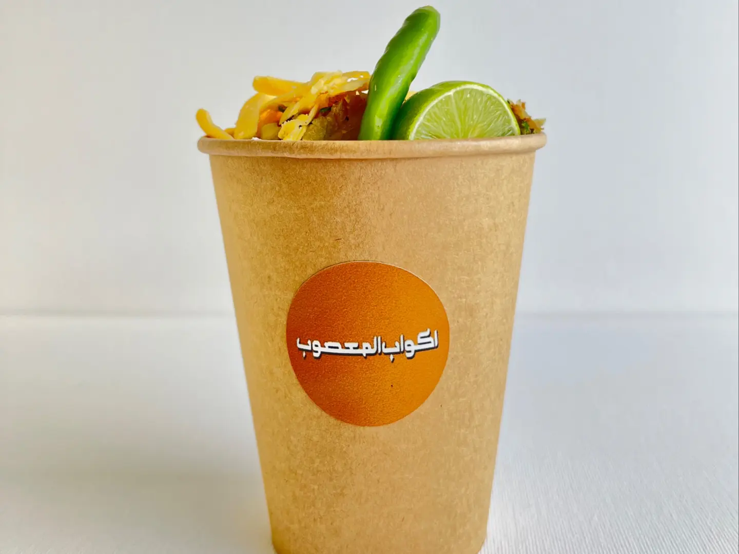 A Cup Of Vegetables With Cheddar Cheese