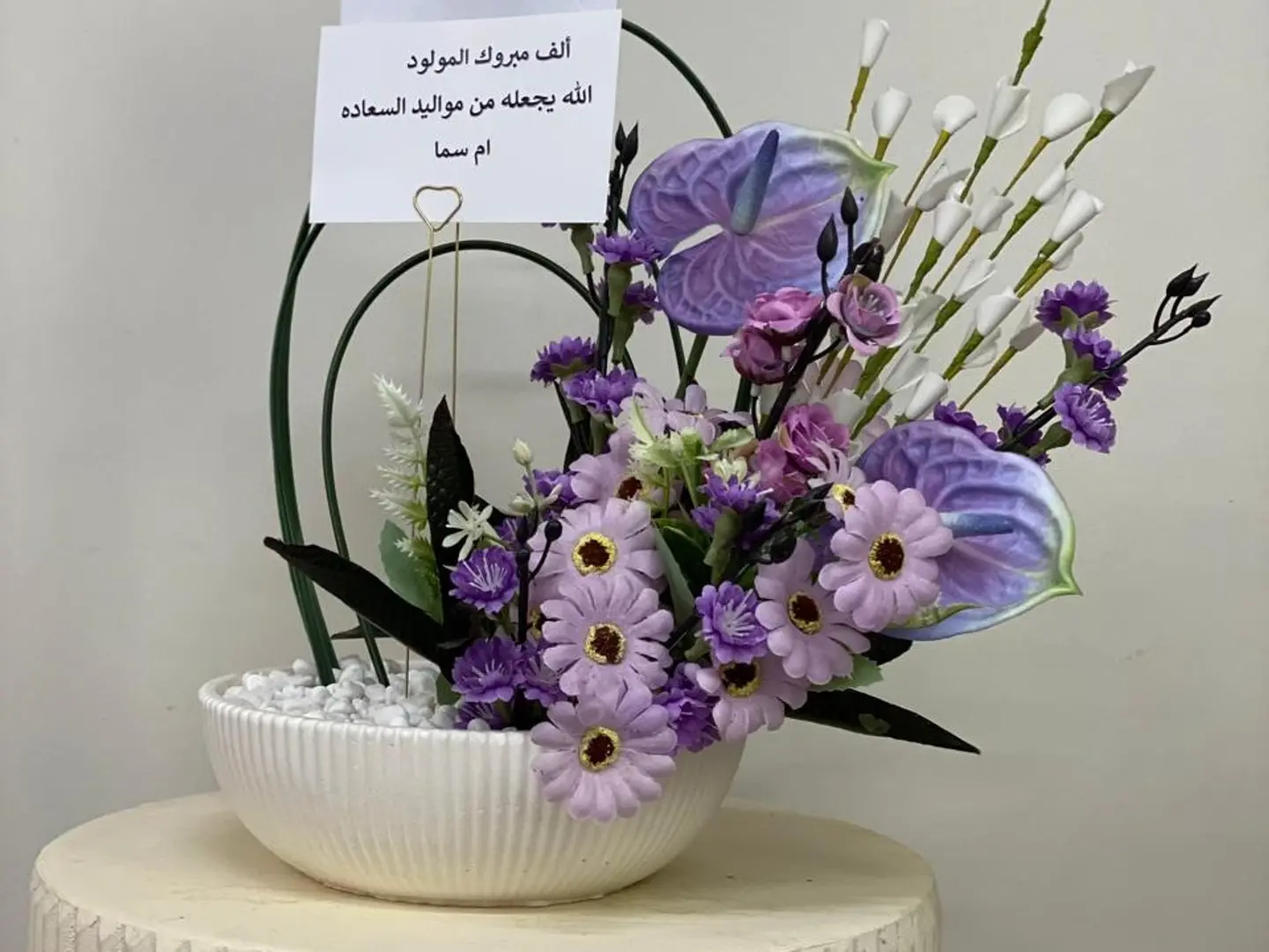 A White Vase With Purple Flowers