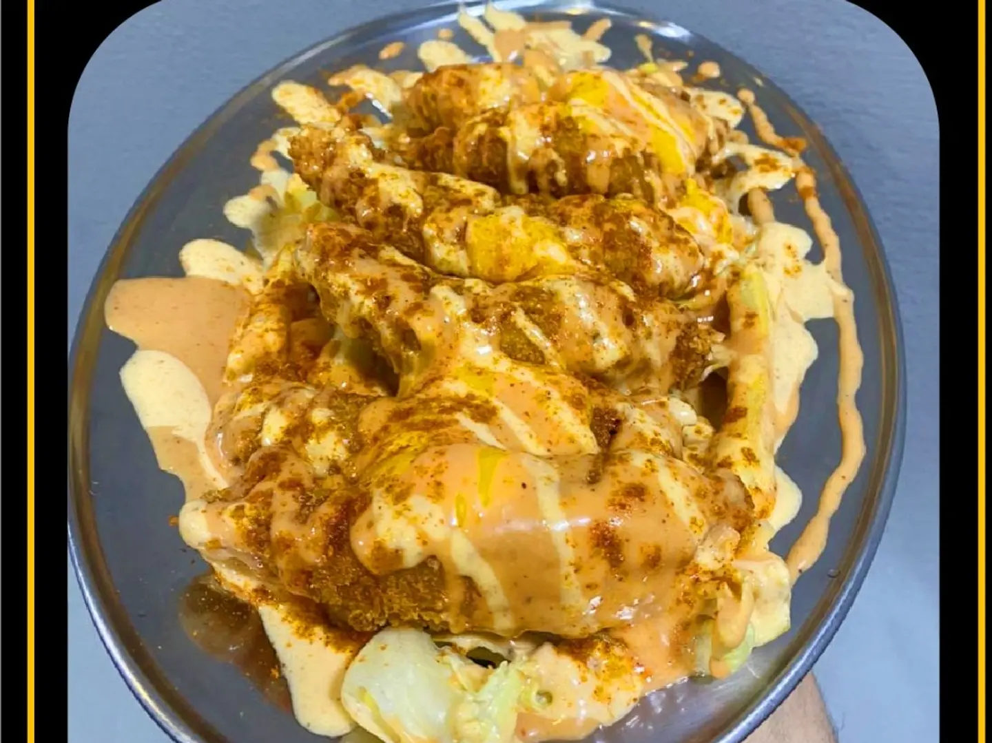 Dynamite Chicken Meal With Lettuce Salad, Potatoes, Chicken, Hot And Cold Sauces, And Liquid Cheddar Cheese