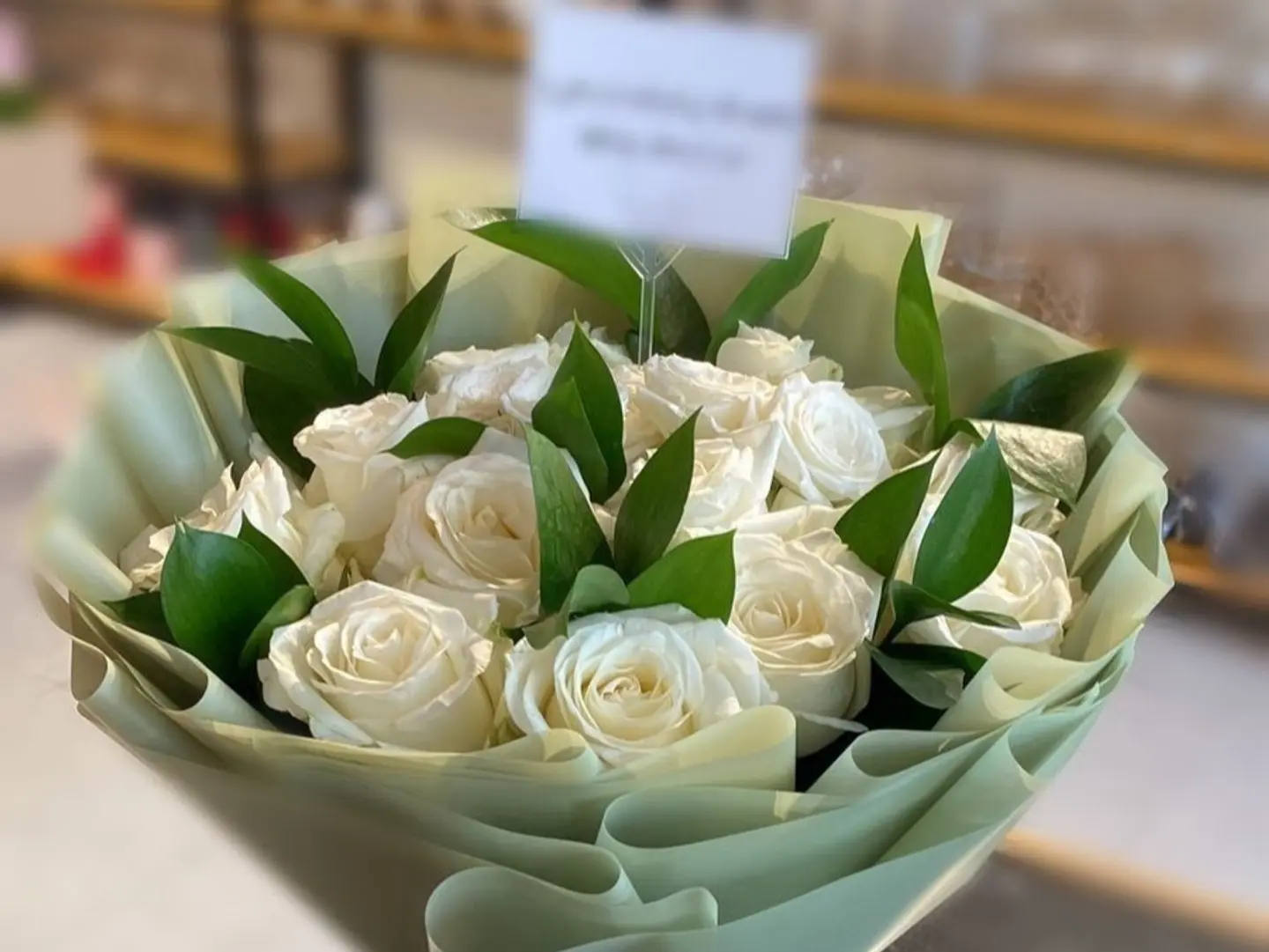 Bouquet With White Roses And Green Wrapping