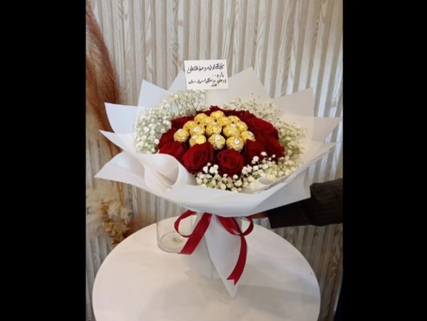 A Bouquet Of Red Roses With Golden Chocolate Balls