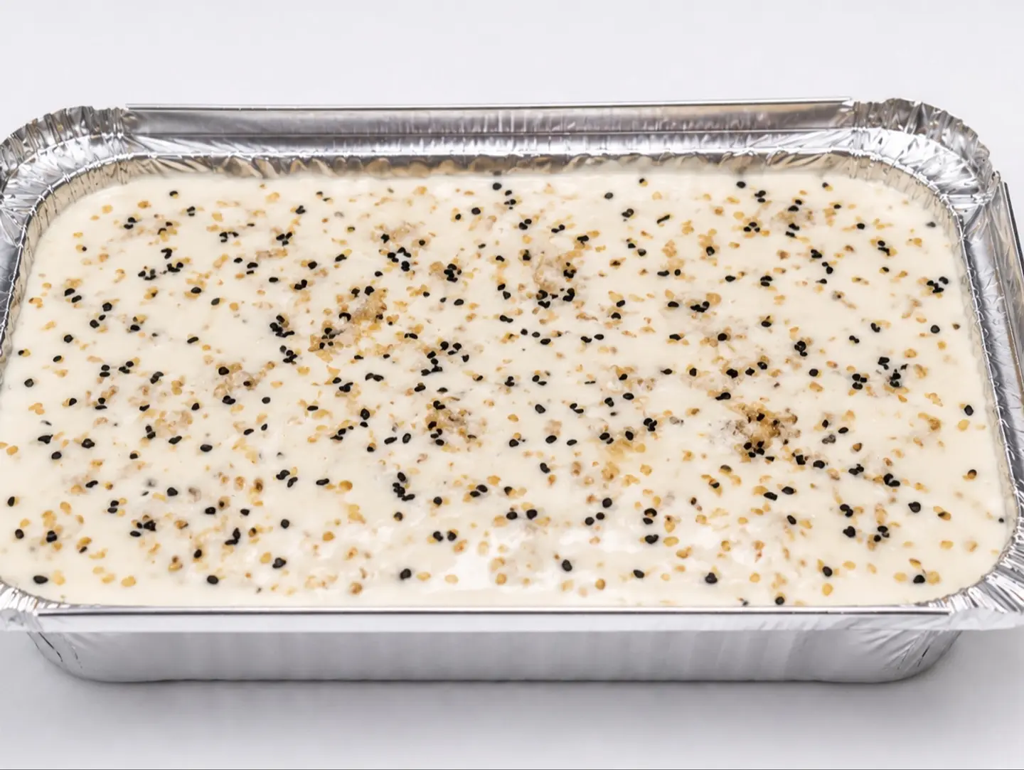 Cream Filled Fatirah Topped With Black Seeds And Sesame.