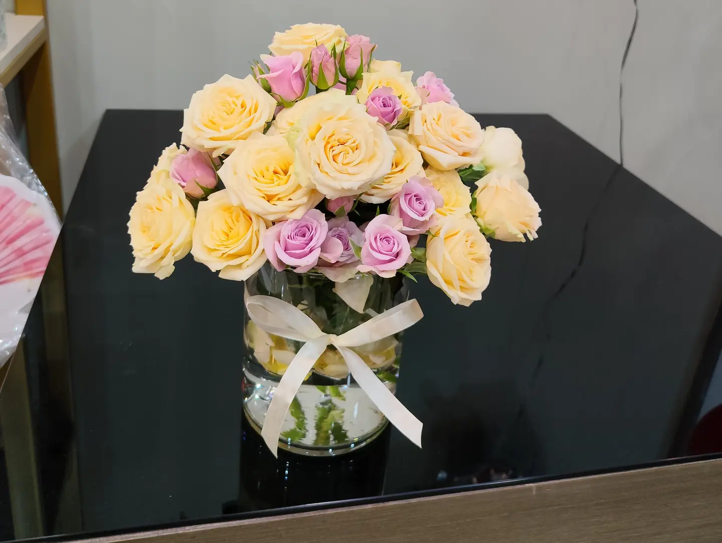 An Elegant Vase Of Natural Roses And A Ribbon