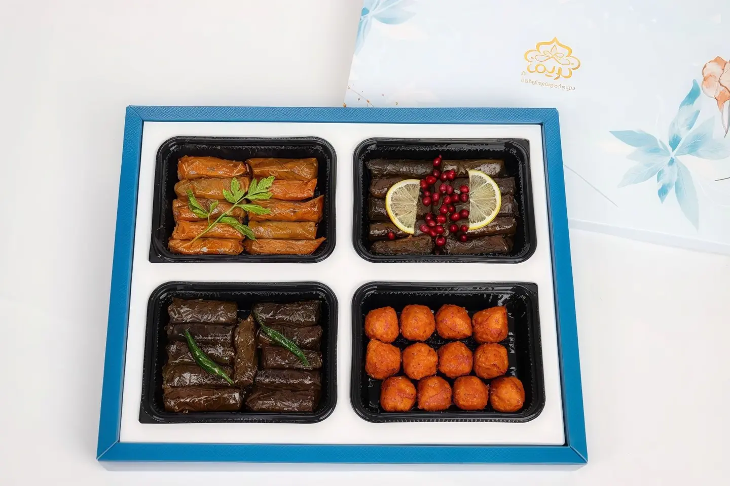 A Box Of Grape Leaves, Cabbage And Kebbeh Snacks
