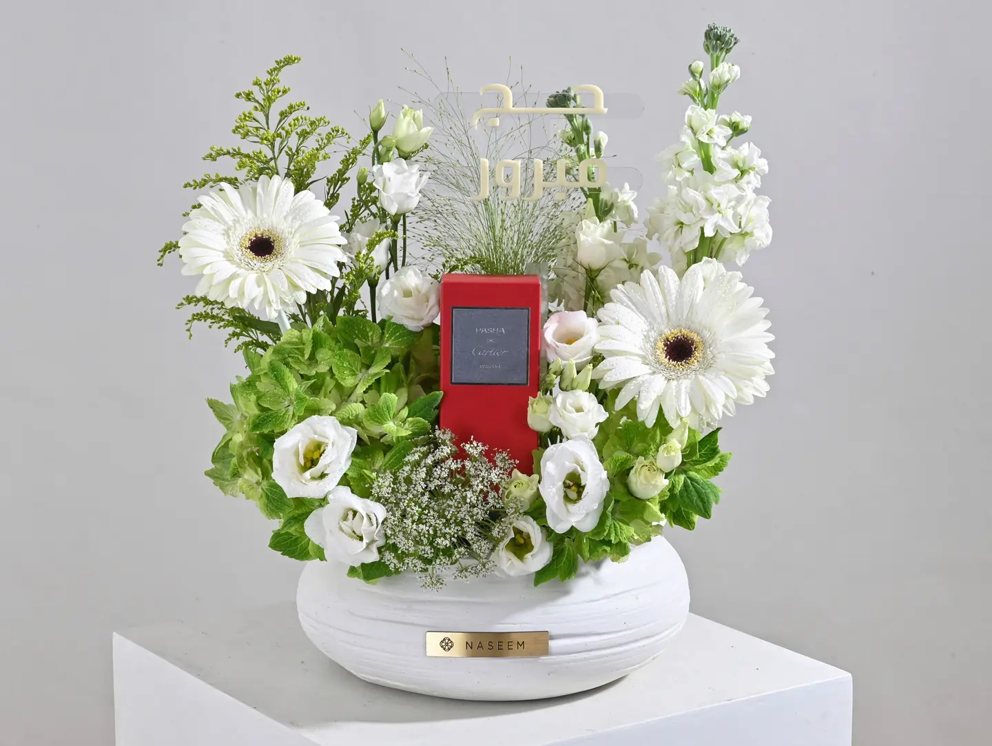 Cartier Perfume With White Floral Arrangement