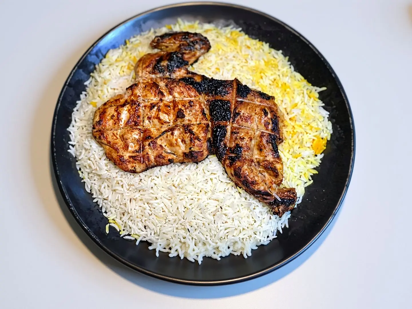 Half A Chicken Grilled On Charcoal With Rice