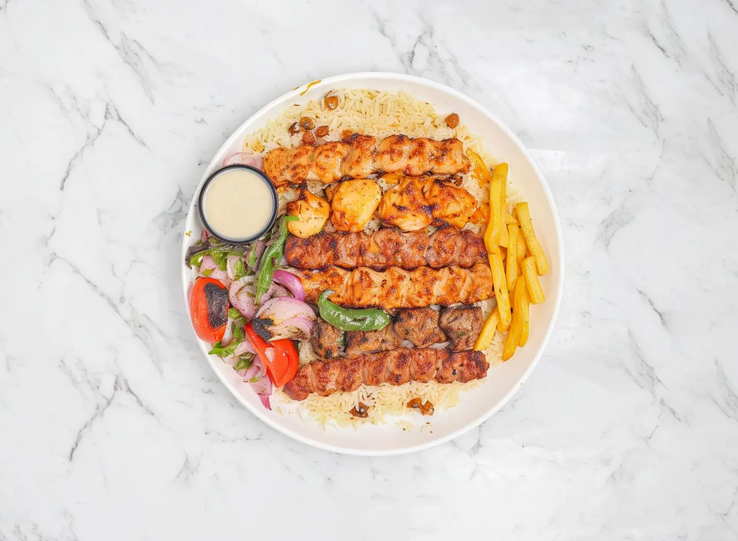 Four Skewers Of Mixed Grill With Rice And Potatoes
