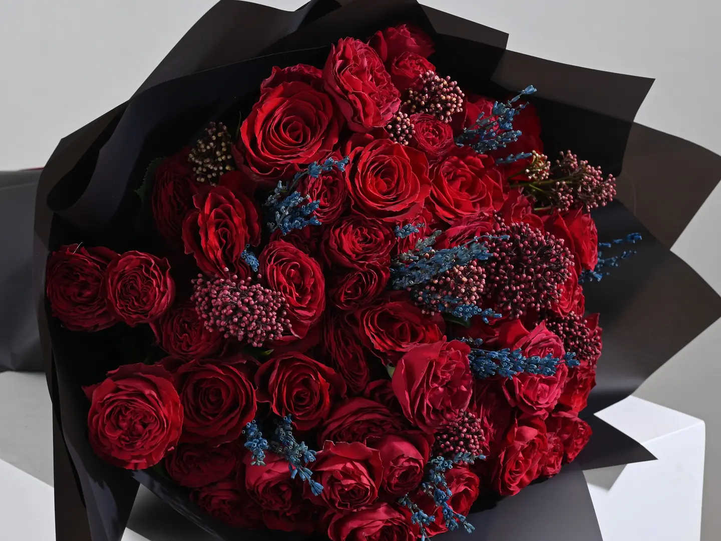 A Bouquet Of Red Roses With Lavender