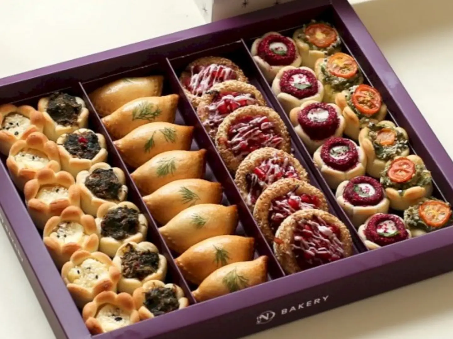 A Box Of Assorted Pastries Consisting Of 38 Pieces
