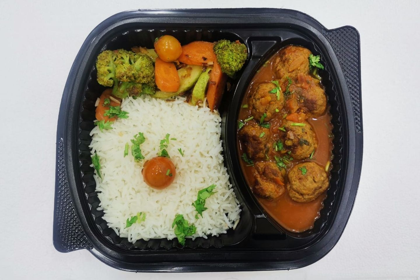 Meatballs Meal With White Rice And Sauteed Vegetables