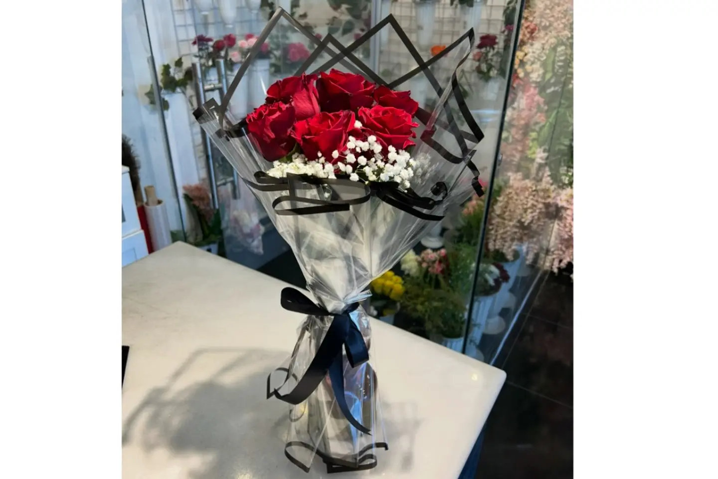 Red Bouquet With Black Transparent Packaging