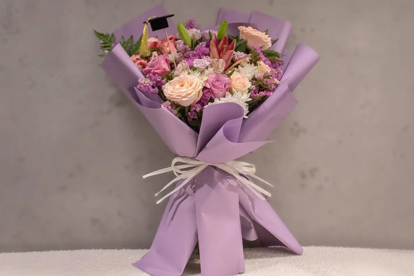 Purple Bouquet With A Miniature Graduation Cap
