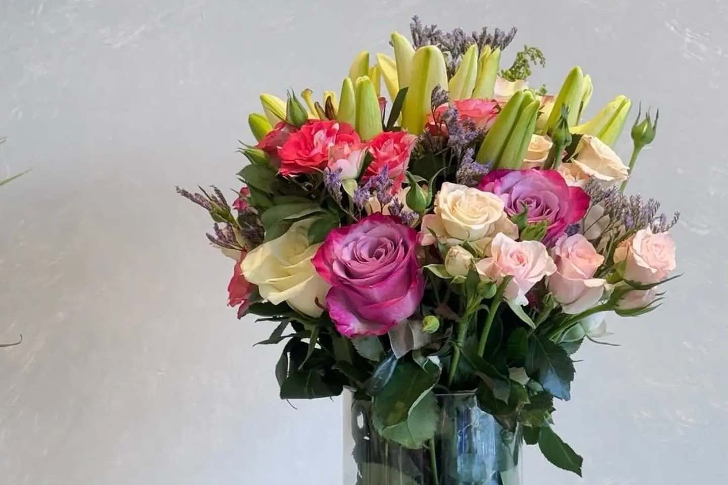 A Vase Of Natural Roses And Lilies