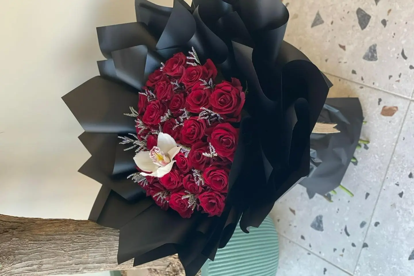 A Bouquet Of Red Roses In Black Packaging S20