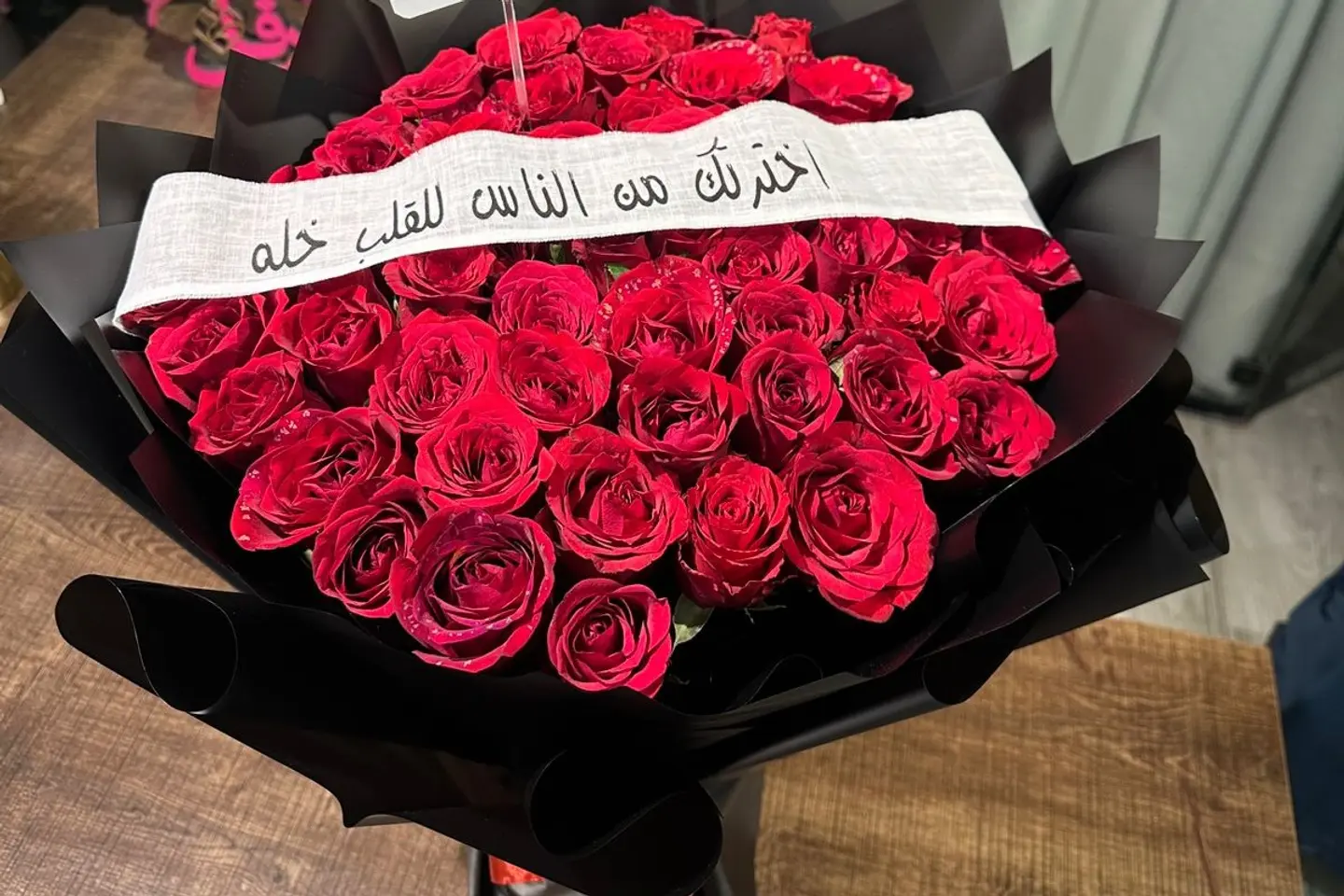 A Bouquet Of Red Roses With Black Wrapping 1
