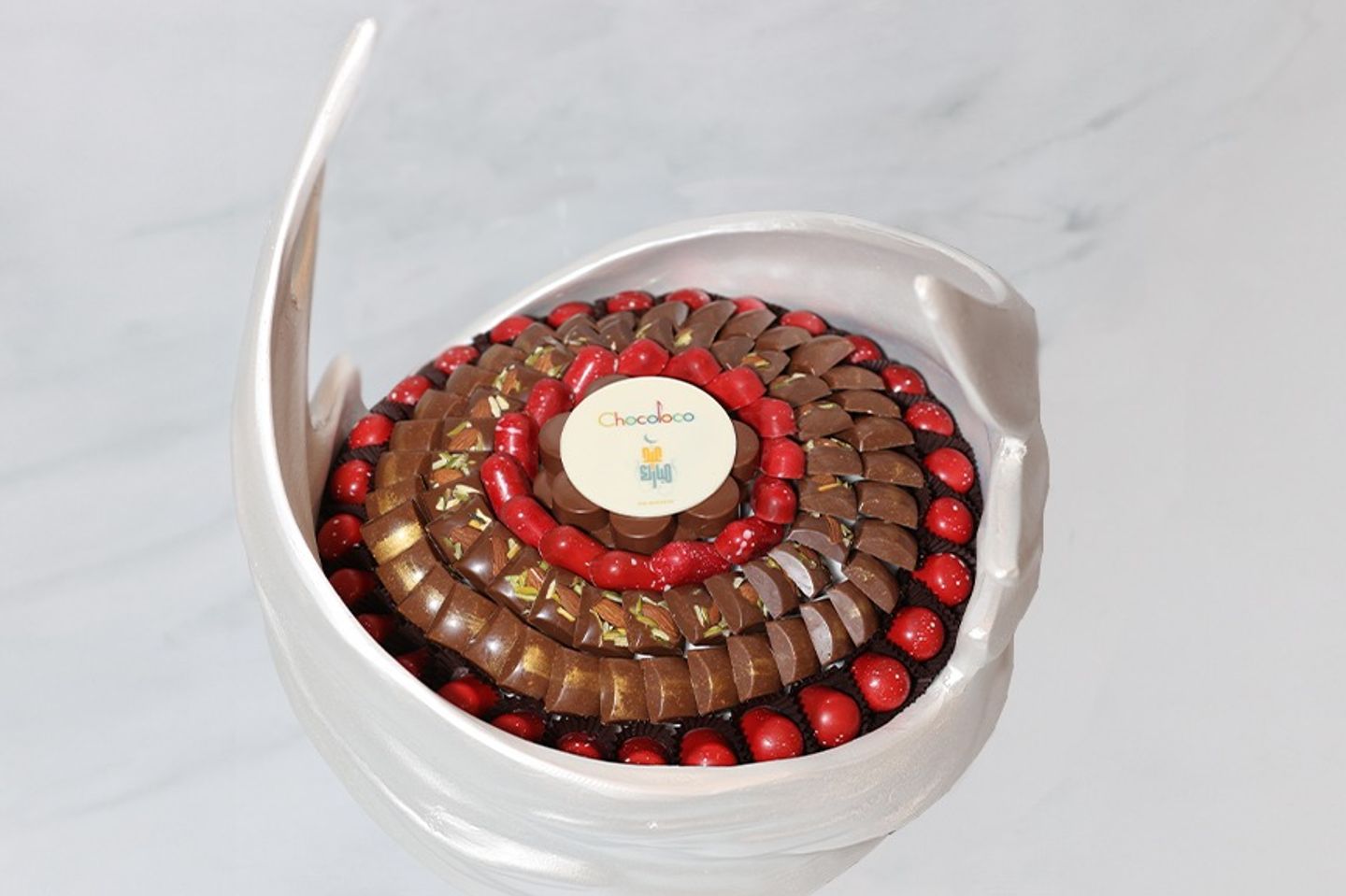 A Round Decorative Tray Containing Classic And Colorful Chocolates