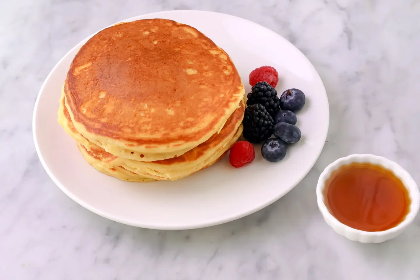 Back To Basics Vanilla Pancake Served With Maple Syrup And Berries